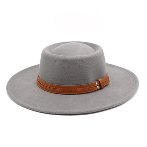Detail of grey wool felt hat with brown leather strap and silver metal buckle studs