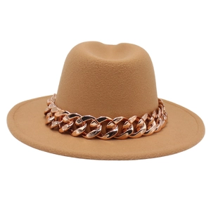 Detail of camel wool felt fedora featuring a thick rose gold acrylic chain decorative band