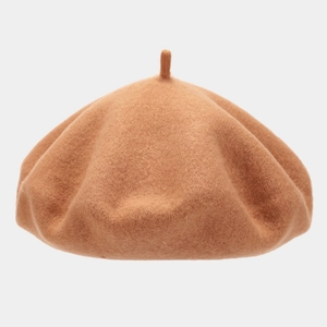 Detailed view of the soft caramel wool felt beret with classic top stem and smooth texture