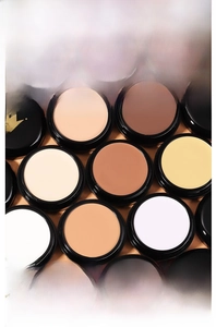 Close-up of professional multi-color cream concealer palette with various corrective shades
