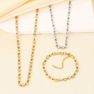 Detail view of gold and silver necklace and bracelet set with cubic zirconia stones