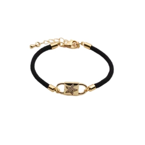 Adjustable black woven rope bracelet featuring a gold star charm with sparkling crystals