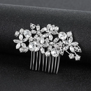 Elegant silver bridal hair comb with crystal flower and hollow leaf design on black background