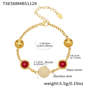 Detail view of gold stainless steel bracelet with zircon and red glass stone stones