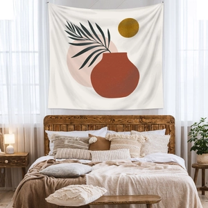 Detail of bohemian tapestry featuring sun and leaf art hanging over a cozy wooden bed