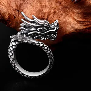 Vintage dragon head ring with intricate scales and open adjustable silver band