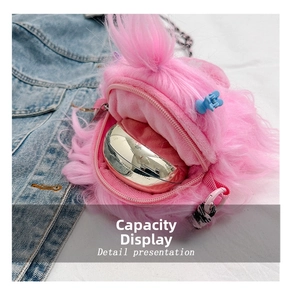 Detailed interior of plush pink monster bag showing storage capacity for cosmetics