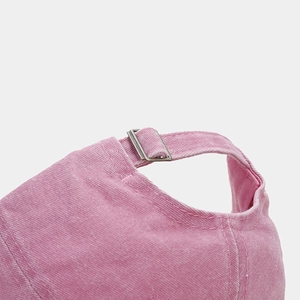 Detail of adjustable metal buckle and stitching on pink washed cotton baseball cap