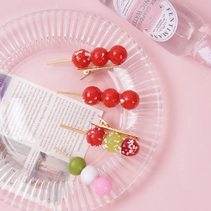 Funny 3D food hair clips featuring realistic candied haws and dango skewers on gold duckbill clips