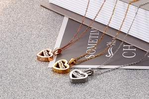 Close-up of heart-shaped mama pendants in rose gold, gold, and silver stainless steel