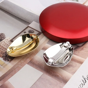 Detailed back view of metallic eggshell hair clip showing sturdy spring fastener