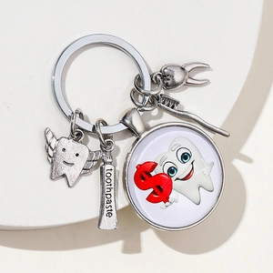 Detail view of dentist theme keychain with toothpaste, toothbrush, and tooth charms