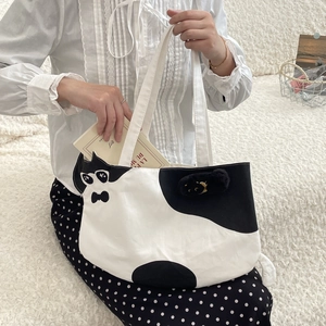 Detail of cute cat graphic canvas tote bag with wide strap and large capacity
