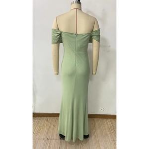 Detail of light green off-shoulder evening dress with sequins and back zipper