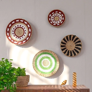 Detail of woven seagrass wall plates set with bohemian patterns on a neutral wall background
