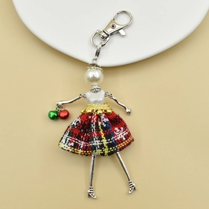 Detailed view of handmade doll keychain featuring red plaid skirt and pearl head detail