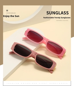 Detailed view of trendy rectangular sunglasses with thick frames and golden hinge accents