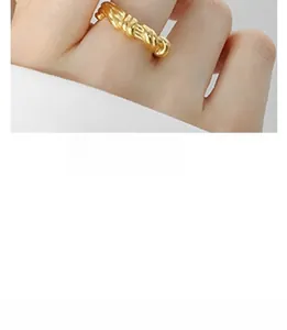 Detail of twisted 18K gold plated ring featuring a sophisticated woven rope texture design