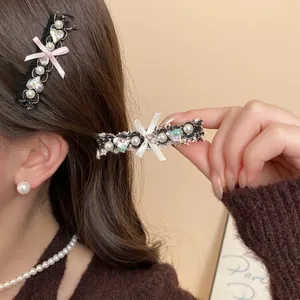 Lace bow hair clip with heart rhinestone and pearls worn by a model for elegant styling