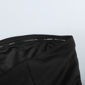Detail view of the inner anti-slip silicone strip on black tube dress neckline