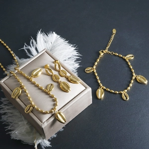 Exaggerated gold seashell jewelry set with necklace earrings and bracelet on display