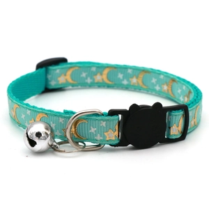 Teal pet collar with gold and silver moon star patterns, bell and safety buckle