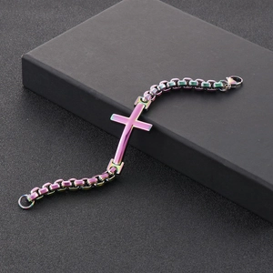 Macro shot of iridescent rainbow cross pendant and thick stainless steel box chain