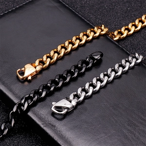 Men's Cuban link chain in gold, black, and silver stainless steel on black leather
