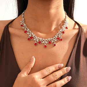 Detail of vintage necklace with silver vines and red teardrop crystal pendants