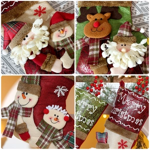Detail of Christmas stocking textures with 3D applique Santa, snowman, and reindeer figures