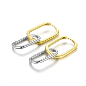 Macro view of S925 silver wave hoop earrings featuring interlocking gold and silver tones