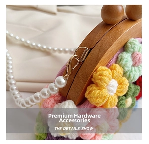 Close-up of golden metal clasp with white pearl strap on handmade floral crochet bag