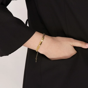 Close-up of golden braided snake chain bracelet on model wrist with extension chain