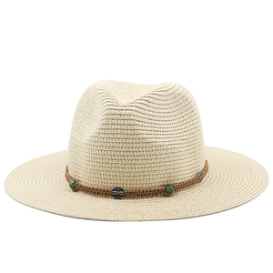 Detail of bohemian straw hat with brown braided strap and vintage green bead accents