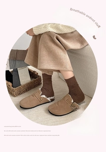 Brown suede mules with plush fleece lining paired with minimalist dark brown cotton socks