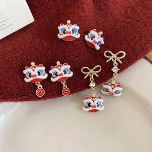 Oriental lion dance stud earrings set with red tassels, pearls, and golden accents