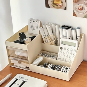 Detail view of cream desk organizer showing multi-compartment slots and dual drawers