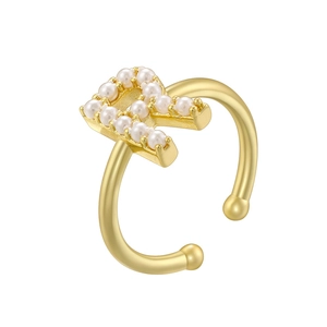 Detail of gold letter R ring with pearl inlay showing elegant open band craftsmanship