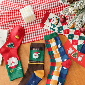 Detailed knit texture of Christmas cotton socks with festive Santa and tree patterns