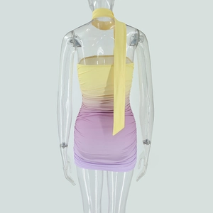 Detail view of backless yellow and purple gradient dress with ruched bodycon design