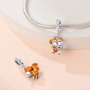 Squirrel playing guitar charm with orange enamel finish on a silver bracelet chain