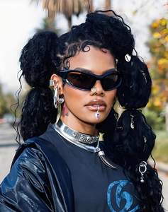 Close-up of black Y2K sports sunglasses with metallic necklace and silver gothic earrings