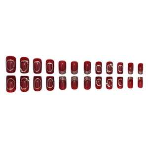 Deep red press-on nails with gold glitter, pearls, and line art in short square shape