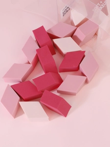 Macro detail of diamond-shaped non-latex makeup sponges in a clear plastic box