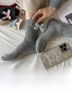 Detail of wool-blend grey crew socks for women with blue bow and soft cotton texture