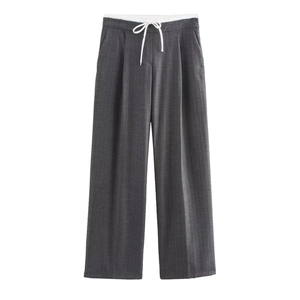 Detail view of dark grey wide leg trousers with a high waist and white drawstring tie