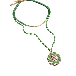 18k gold plated glass beaded flower necklace with green stones and red center detail