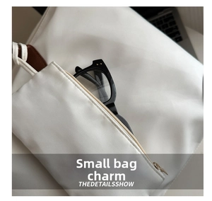 Close-up of a white waterproof oxford small pouch showing storage for black glasses