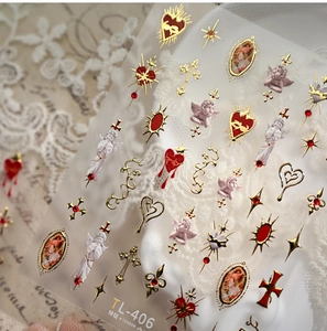 Macro shot of TL-406 nail stickers with golden baroque hearts and vintage angels