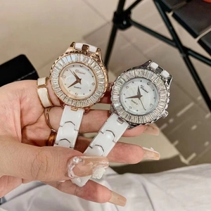 Detail of luxury ceramic watches with crystal bezels and mother of pearl dials